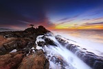 coast sunset waves rock formations rocky coastline shore stock photo