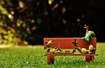 frogs bank bench relaxed figure fun quiet relaxation stock photo
