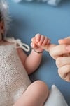 newborn baby hand holding motherhood love softness bonding stock photo