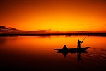boat dusk silhouette dawn sunrise sunset lake water stock photo