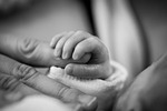 baby child birth trust hand macro fear love stock photo