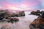 beach water stones long exposure vietnam haze nature stock photo