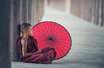 boy monk umbrella child kid sitting rest relax stock photo