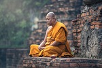 buddhist monk sitting meditation zen meditate meditative ancient stock photo
