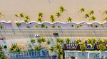 beach buildings cars palm trees nature road sand stock photo