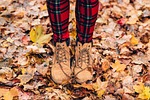 autumn boots dry leaves fall feet footwear outdoors stock photo