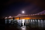 san francisco oakland bay bridge water reflections moon stock photo
