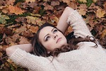 woman brunette lying down rest resting young fall stock photo