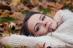 autumn girl lying down beauty makeup cosmetics face stock photo