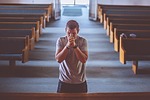man praying church prayer pews aisle god christianity stock photo