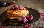 pancakes maple syrup raspberries breakfast pouring plate stack stock photo