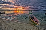 evening lagoon dugout canoe widi islands halmahera indonesia stock photo