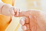 baby hands fingers infant child father parent parenthood stock photo