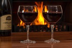 red wine glasses log fire beverage alcohol drink stock photo