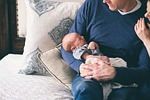 baby people parents father mother sofa couch sleep stock photo