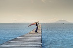 women jetty sea shawl pier sky nature ocean stock photo