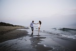 valentines day background couple beach walking holding hands stock photo
