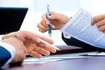 laptop office hand writing business document contract paper stock photo