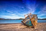 boat sea sky landscape nature beach sand old stock photo