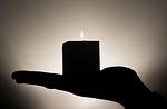 candle hand candlelight flame shadow silhouette burning incandescent stock photo