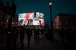 london neon sign advertising people sightseeing night illuminated stock photo