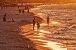 beach vacation golden hour people tourists holiday coast stock photo