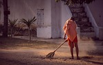 monk monastery sweep clean broom stock photo