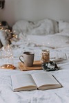 camera book candle read cozy bed lamp bokeh stock photo