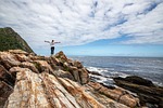 woman coast sea rocky rock formations ocean seascape stock photo