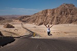 woman jump nature desert jumping road street badlands stock photo