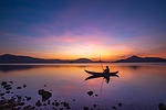 lake boat fisher man landscape nature sunset sun stock photo