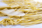 fresh pasta manufacturing tagliatelle traditional food yellow plain stock photo
