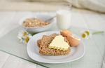 breakfast in bed cereal loaf butter bedroom lifestyle stock photo