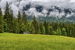 forest clouds hut scenic nature mountains upper bavaria stock photo