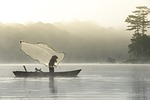 fisherman fishing lake tuyen lam da lat vietnam stock photo