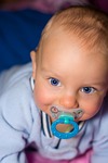 infant boy small face child portrait blue eyes stock photo