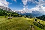 field mountains rural village meadow landscape mountain range stock photo