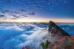 mountain peak clouds sea of horizon sunrise dawn stock photo