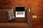 home office notebook couch sofa canapé computer laptop stock photo
