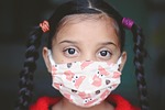 girl child face mask covid kid young covid-19 stock photo