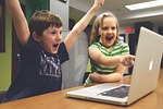 children win success video game play happy macbook stock photo