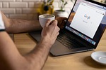 freelance work google macbook drinking coffee apple product stock photo