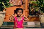 india child girl big eyes pupils bright colors stock photo