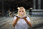 happy holidays woman confetti sparkles blonde fun celebration stock photo