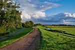 path grass dike clouds northern germany nature reserve stock photo