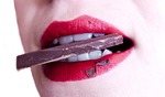 woman mouth teeth sweets chocolate bite stock photo
