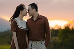 couple meadow walking nature sunset outdoors affection twilight stock photo