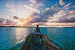 landscape tropical coral reef lagoon sunset wooden boat stock photo