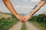 lovers holding hands outdoors nature pride lgbtqia love stock photo