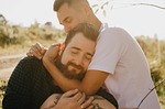 lovers meadow portrait outdoors nature gay couple relationship stock photo